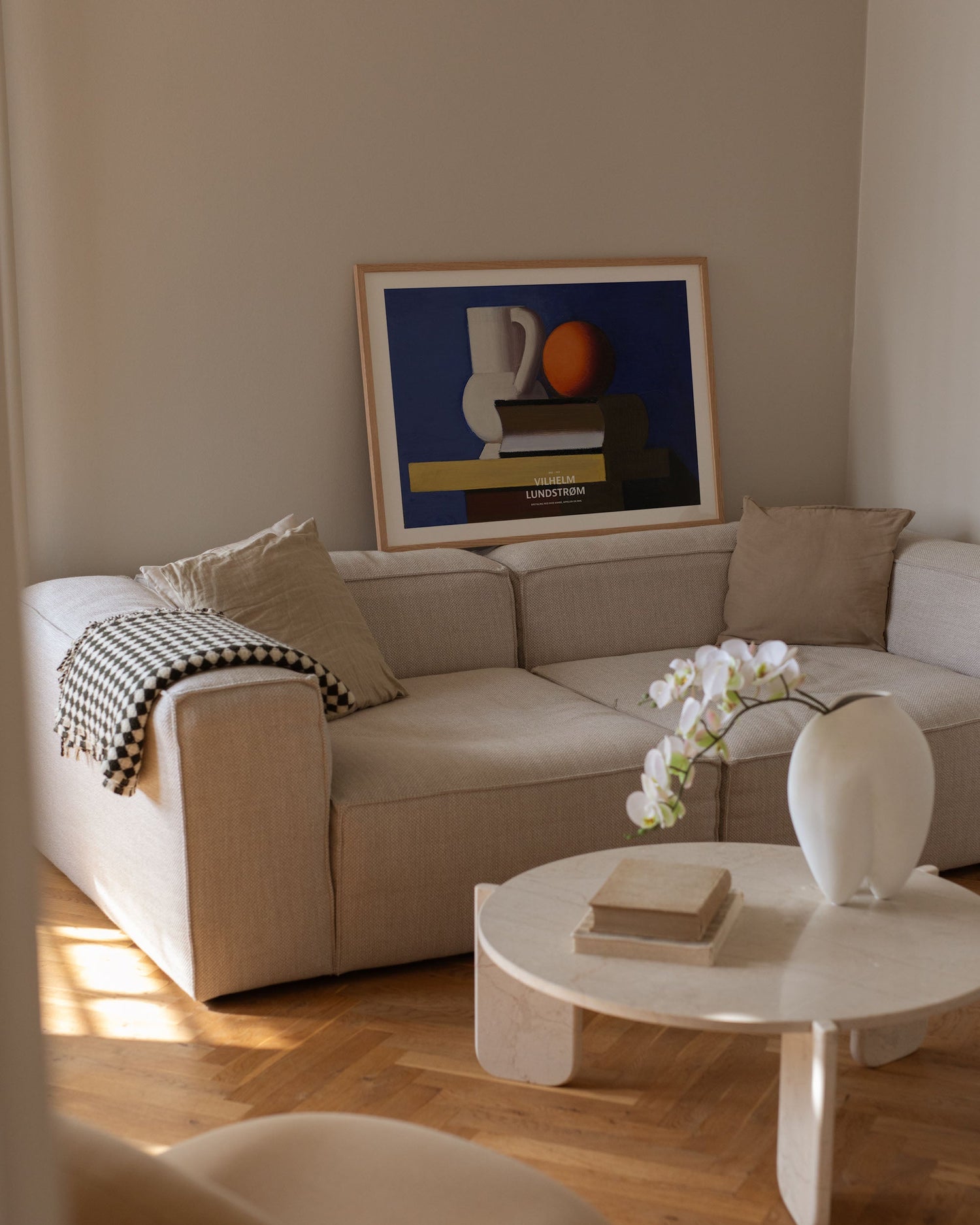 Arrangement with white jug, orange and book