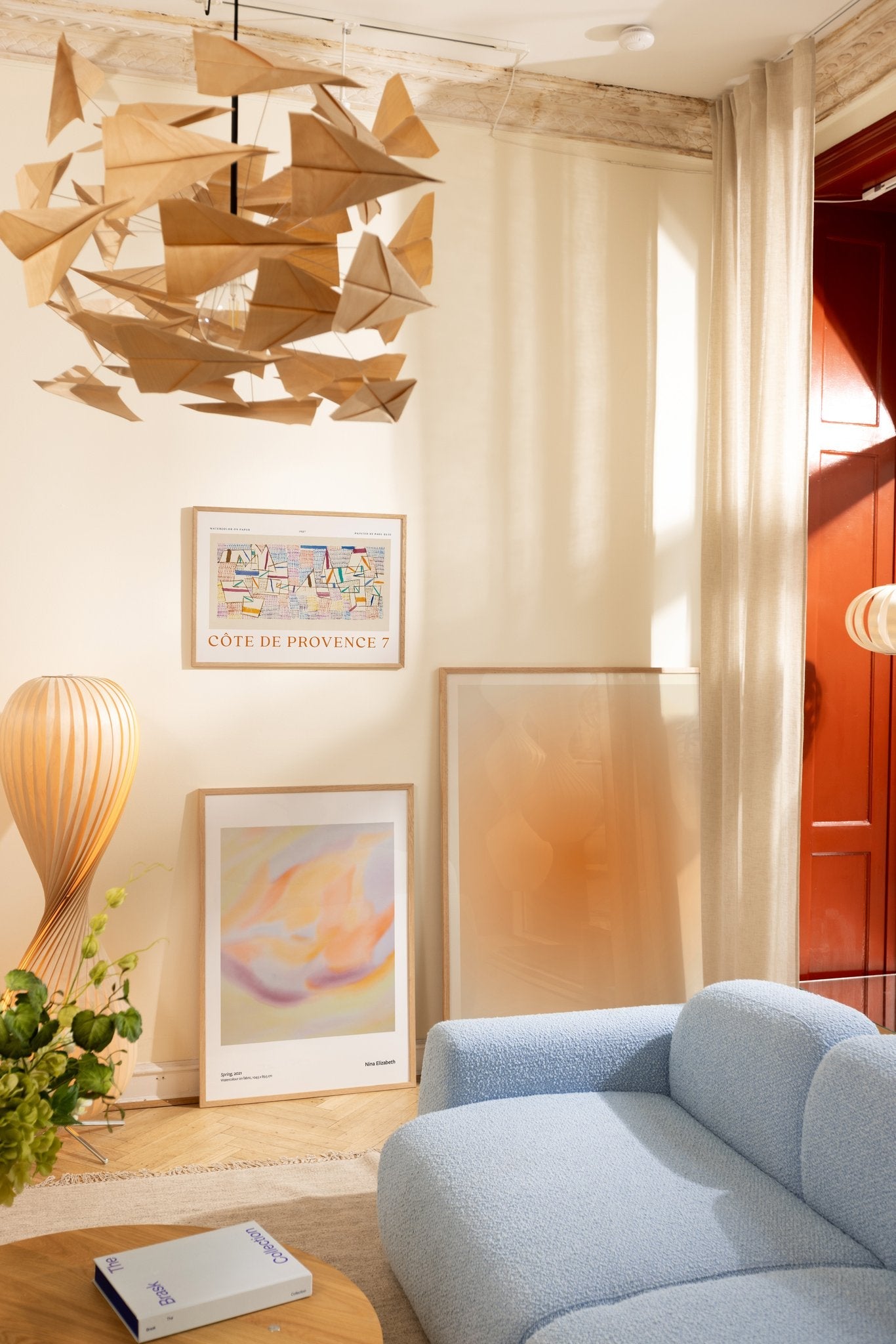 Summery art prints leaning against the wall