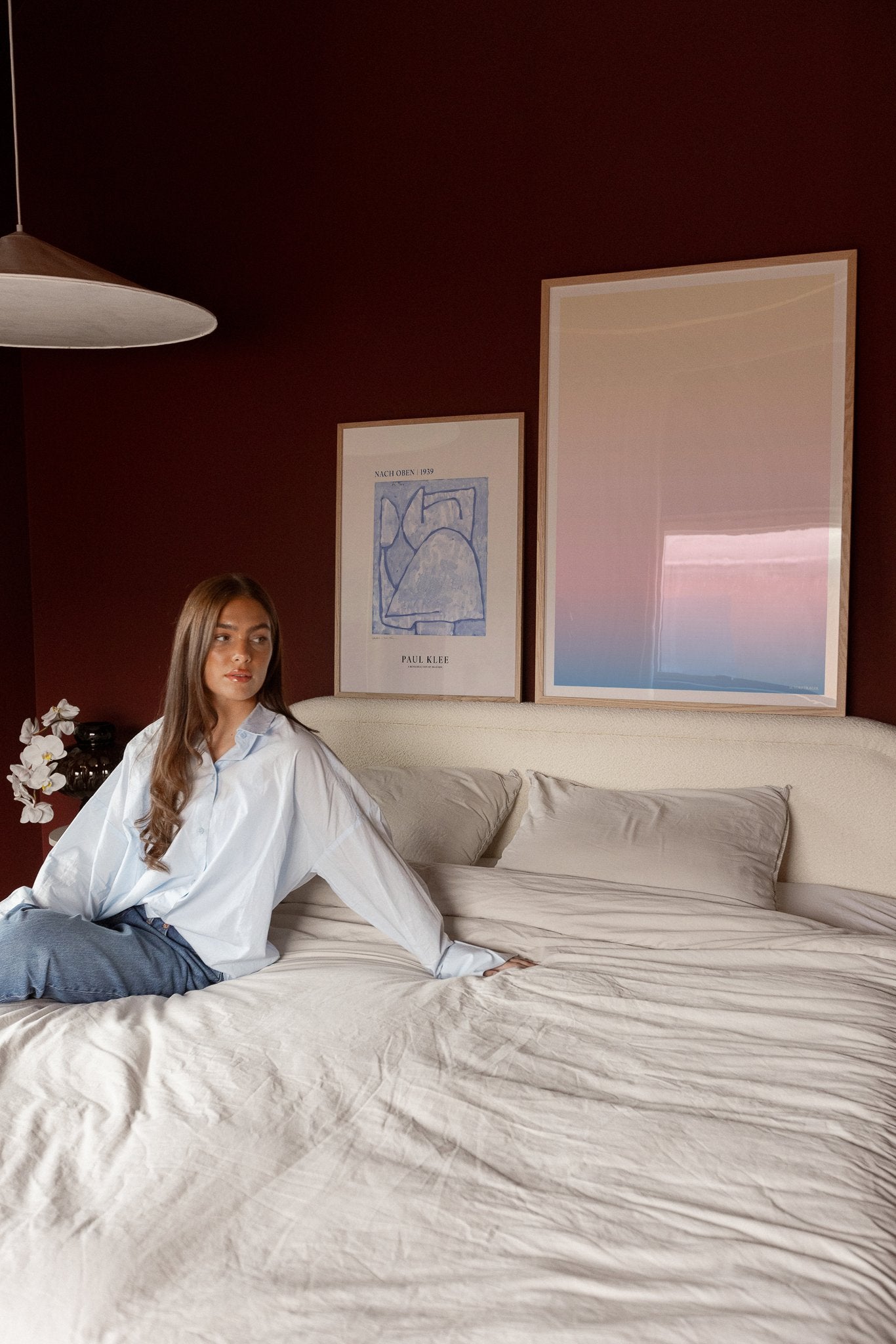 Pastel-colored art prints on headboard